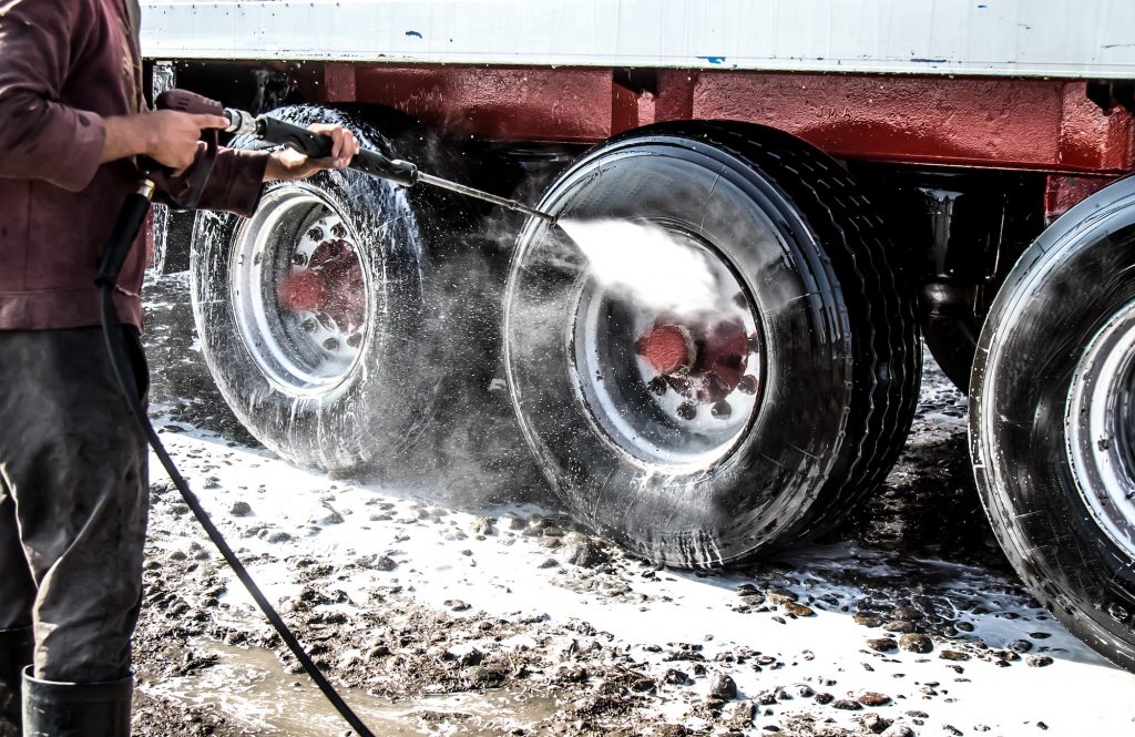 a pressure washer cleaning a fleet's tires