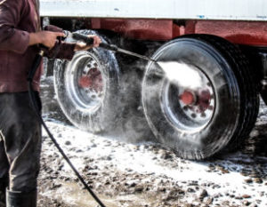 a pressure washer cleaning a fleet's tires
